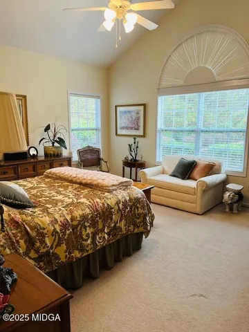 a spacious bedroom with a bed and a table