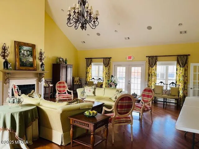 a living room with fireplace furniture and a wooden floor