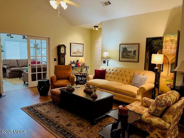 a living room with furniture couches and a flat screen tv