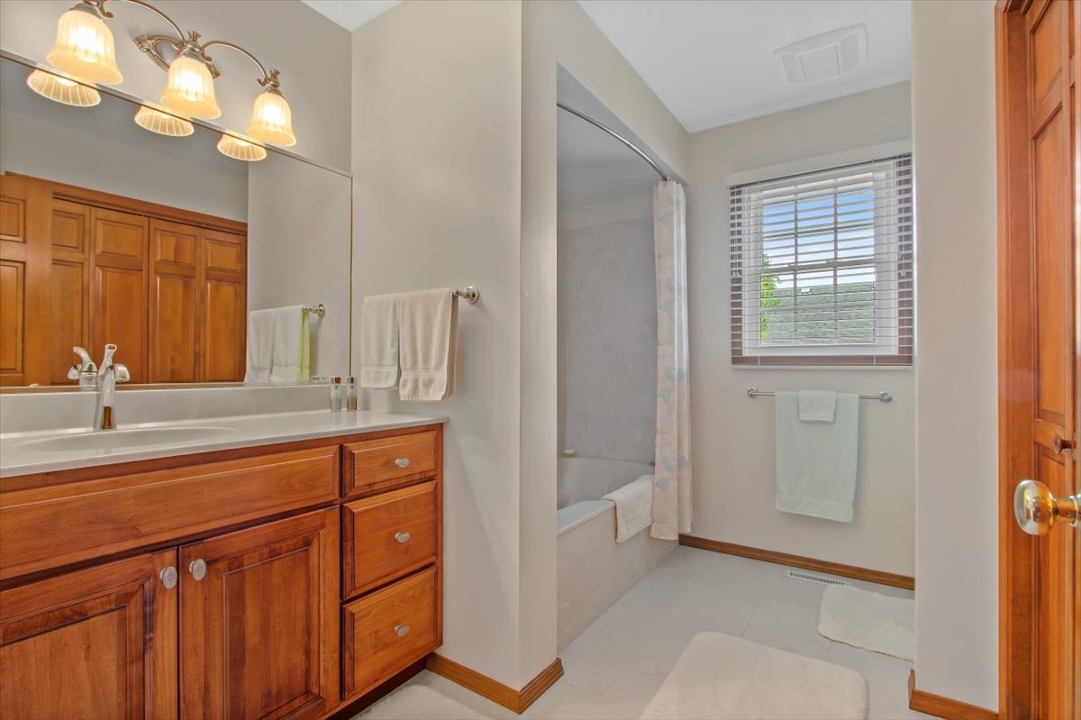 22 Barley Circle Bloomington, IL 61704 - Photo 20 of 30 a spacious bathroom with a double vanity sink and a mirror