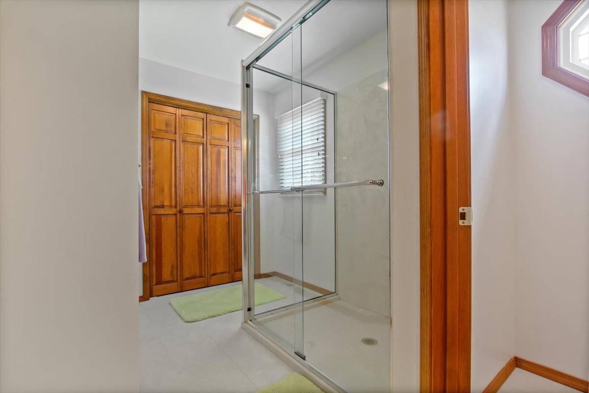 22 Barley Circle Bloomington, IL 61704 - Photo 22 of 30 a bathroom with a glass shower door