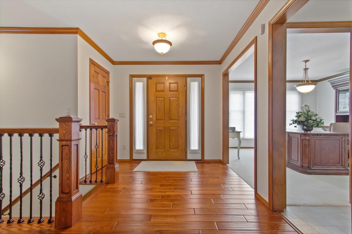 22 Barley Circle Bloomington, IL 61704 - Photo 6 of 30 a view of a hallway with wooden floor and staircase