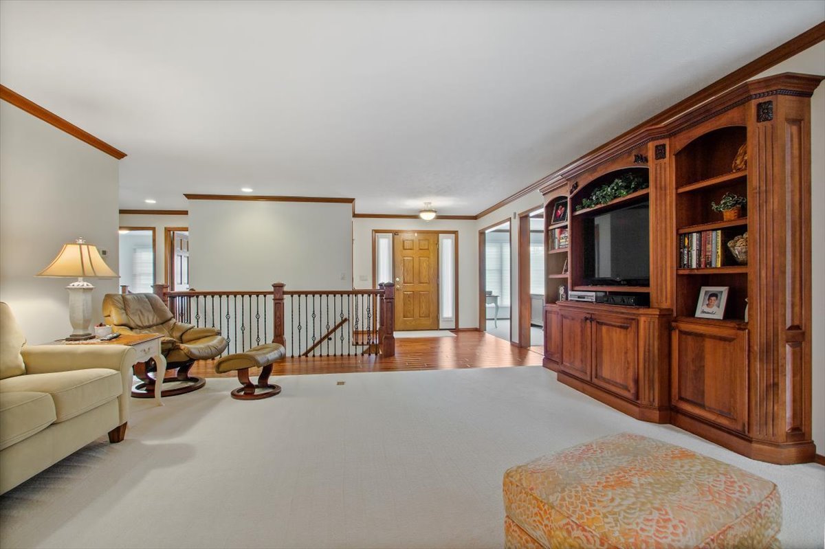 22 Barley Circle Bloomington, IL 61704 - Photo 9 of 30 a living room with furniture gym equipment and a flat screen tv