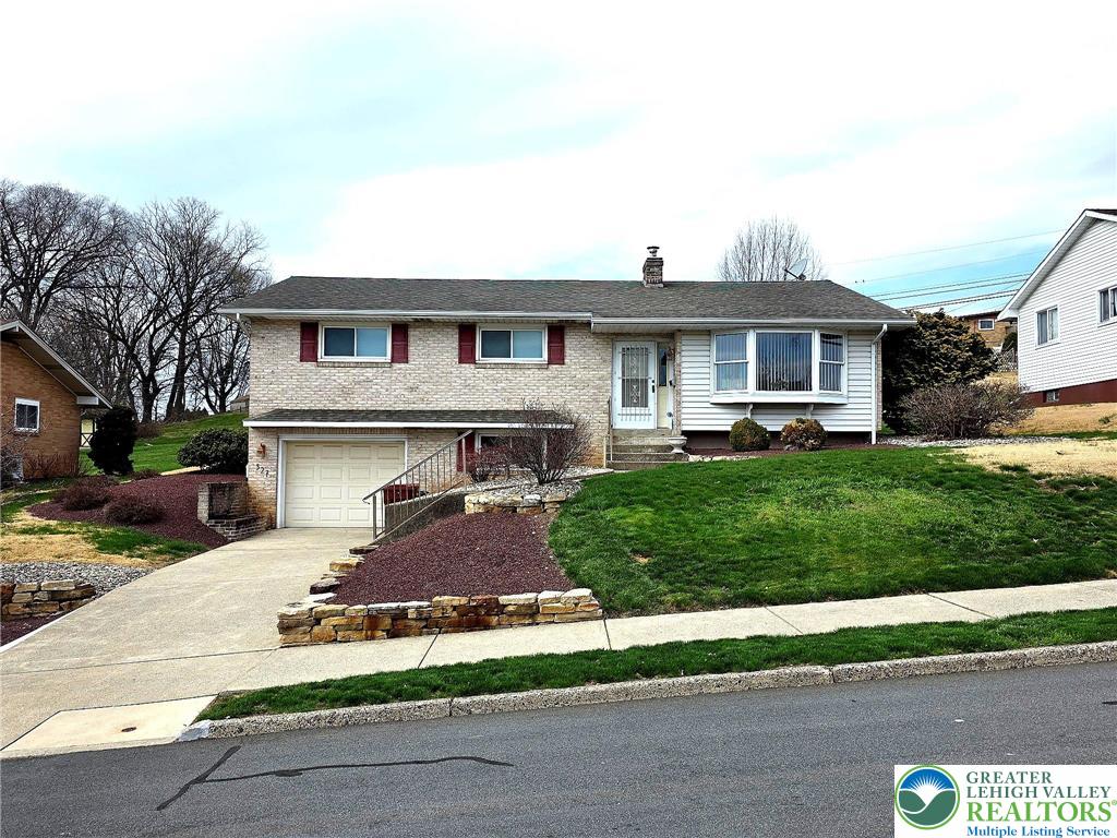 327 Sumner Avenue Whitehall, PA 18052 - Photo 1 of 38 a front view of a house with a yard and garage