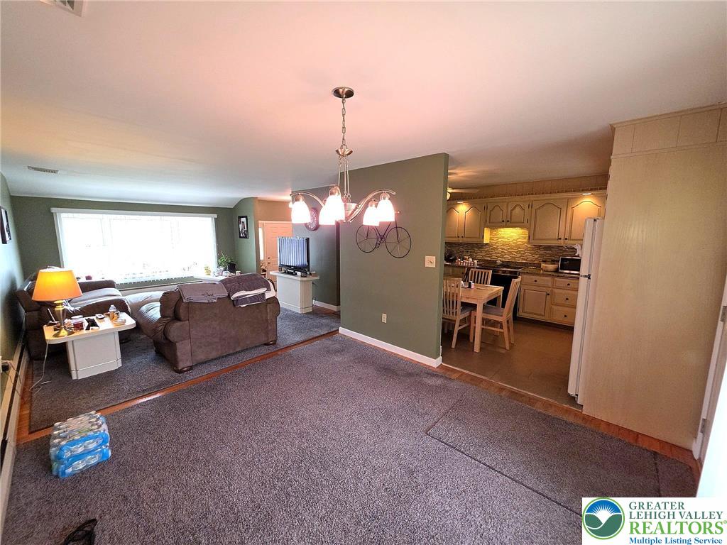 327 Sumner Avenue Whitehall, PA 18052 - Photo 17 of 38 a living room with furniture and a chandelier