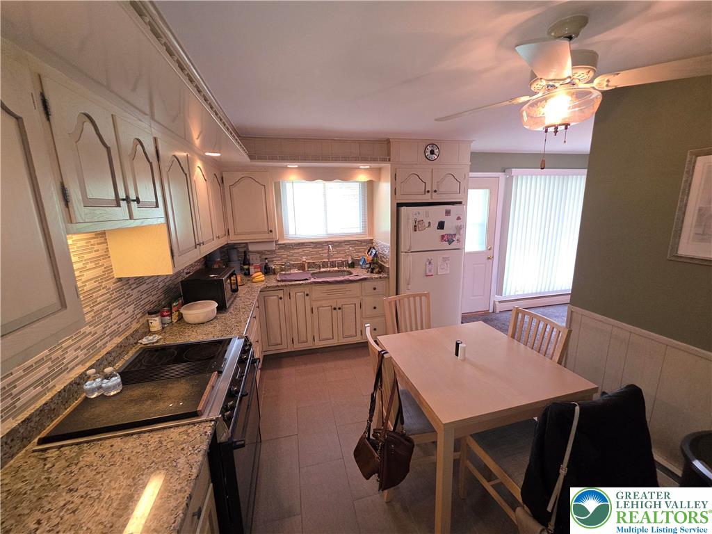 327 Sumner Avenue Whitehall, PA 18052 - Photo 20 of 38 a kitchen with a table chairs and appliances