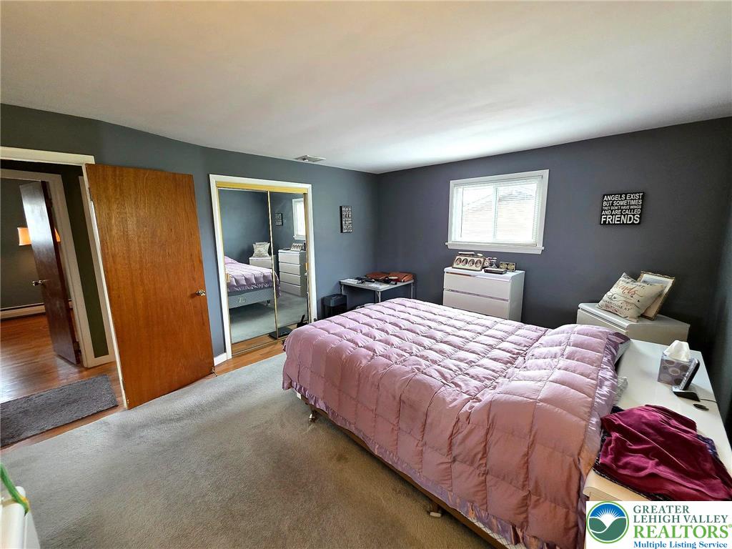 327 Sumner Avenue Whitehall, PA 18052 - Photo 27 of 38 a bedroom with a bed and a large mirror in it
