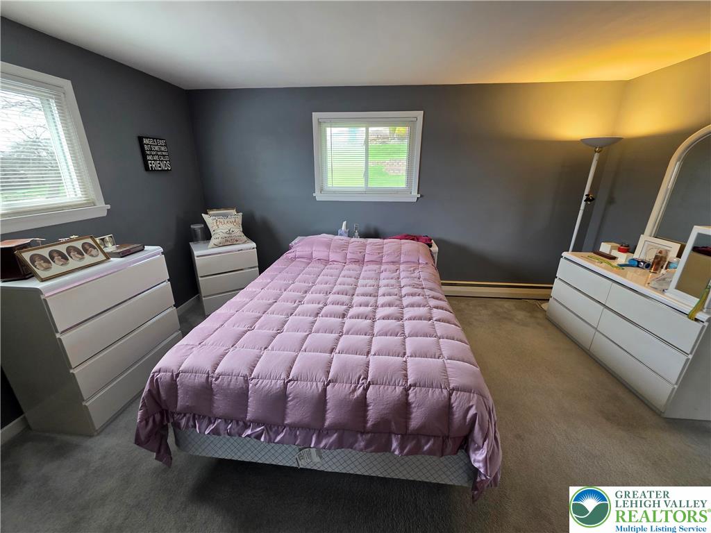 327 Sumner Avenue Whitehall, PA 18052 - Photo 29 of 38 a bedroom with a bed and wooden floor