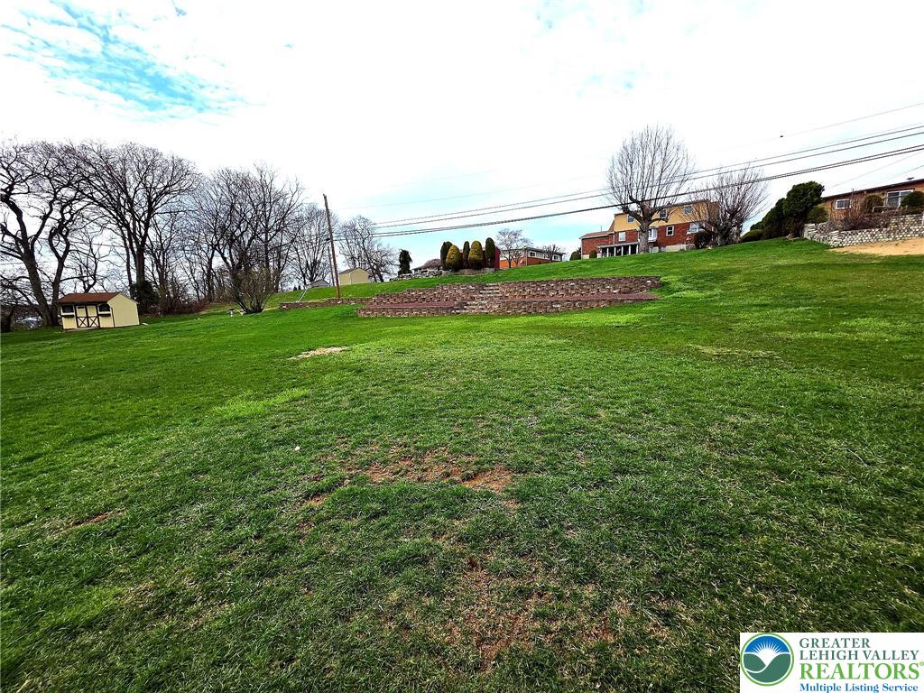 327 Sumner Avenue Whitehall, PA 18052 - Photo 3 of 38 a view of yard with house and car parked in the background