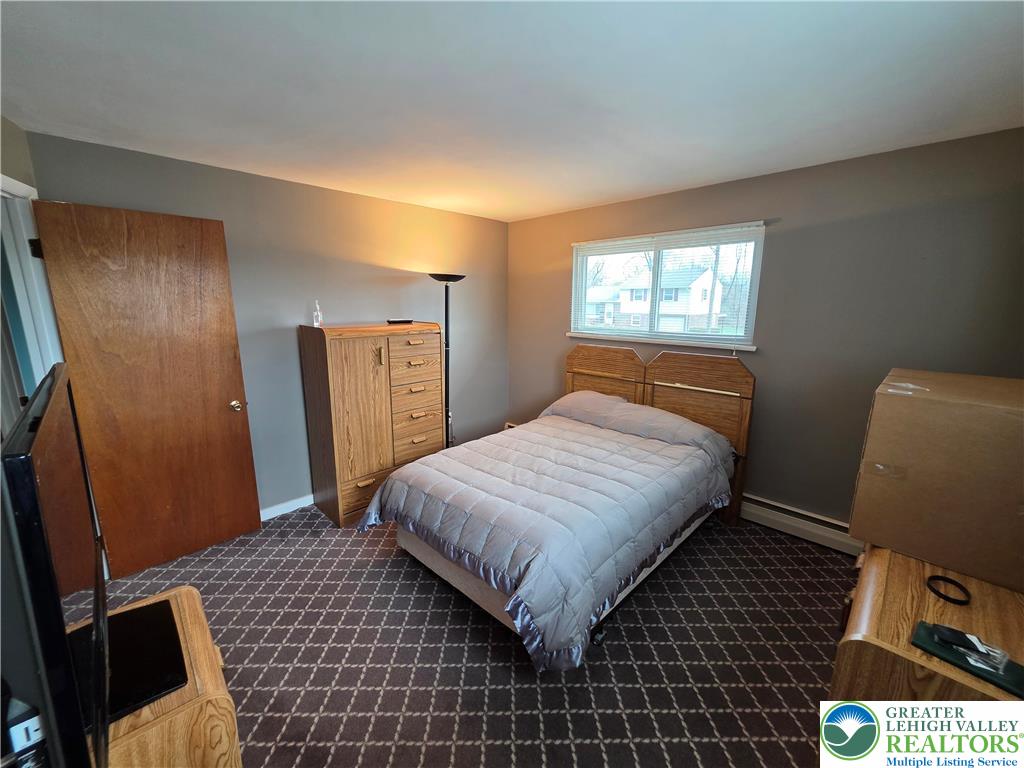 327 Sumner Avenue Whitehall, PA 18052 - Photo 31 of 38 a bedroom with a bed and a mirror