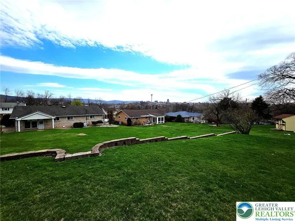 a view of grassy field with house