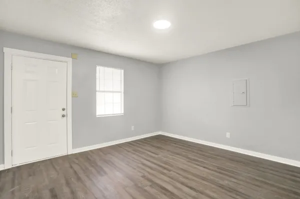a room with a white cabinets and wooden floors