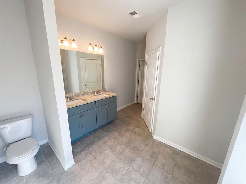 104 Charlie Fuller Road Grantville, GA 30220 - Photo 18 of 19 a spacious bathroom with a sink toilet and mirror