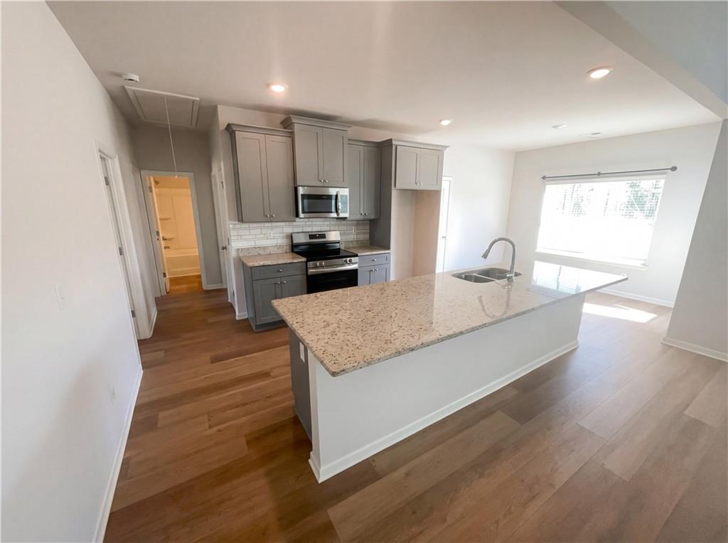 104 Charlie Fuller Road Grantville, GA 30220 - Photo 2 of 19 a kitchen with stainless steel appliances granite countertop a sink stove and refrigerator