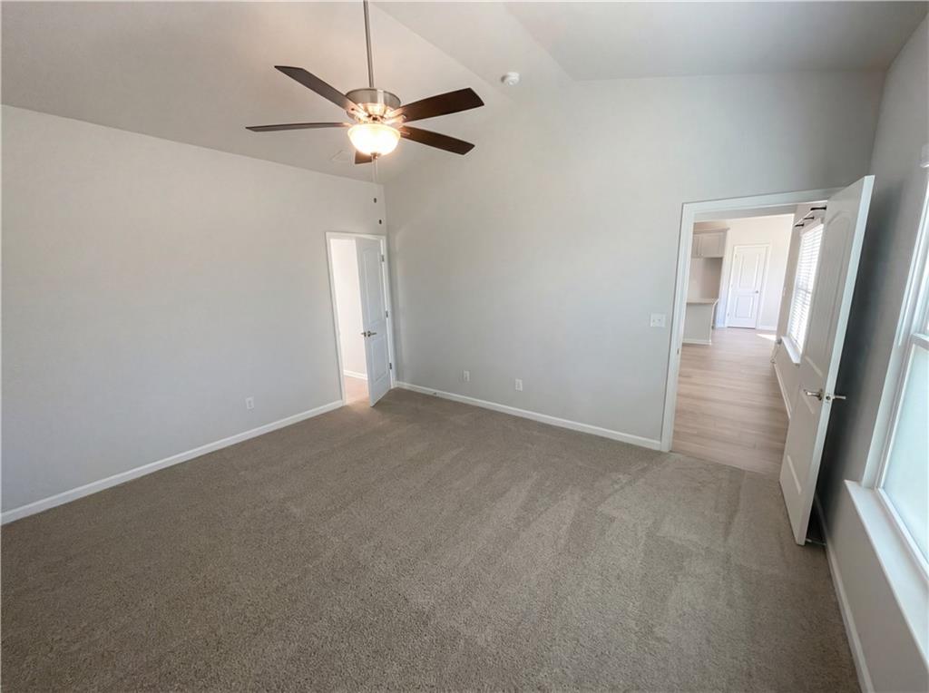 104 Charlie Fuller Road Grantville, GA 30220 - Photo 8 of 19 an empty room with a ceiling fan and entrance