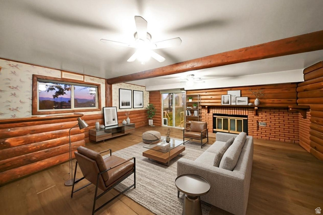 374 West Lakeview Road Lindon, UT 84042 - Photo 34 of 44 Spacious living area featuring exposed wood log walls and a prominent brick fireplace