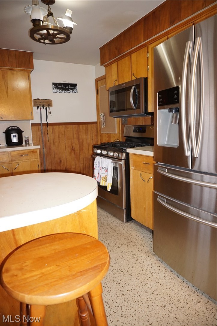 4611 8th Street Northwest Canton, OH 44708 - Photo 11 of 29 Kitchen with a notable chandelier, stainless steel gas range oven, and refrigerator
