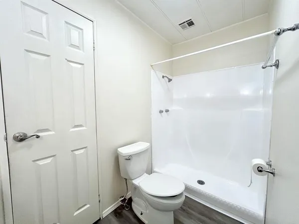 a bathroom with a toilet and shower