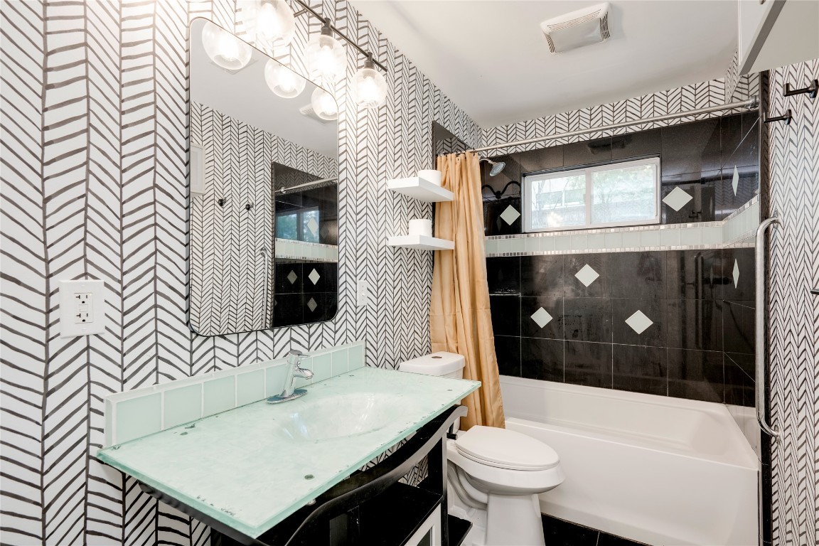 2903 South 5th Street Austin, TX 78704 - Photo 17 of 39 a bathroom with a sink a toilet and shower