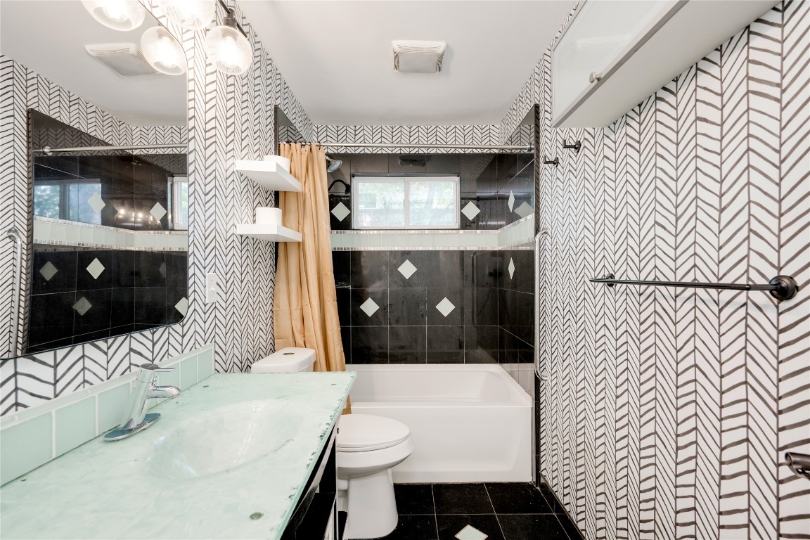 2903 South 5th Street Austin, TX 78704 - Photo 18 of 39 a bathroom with a sink a toilet and shower