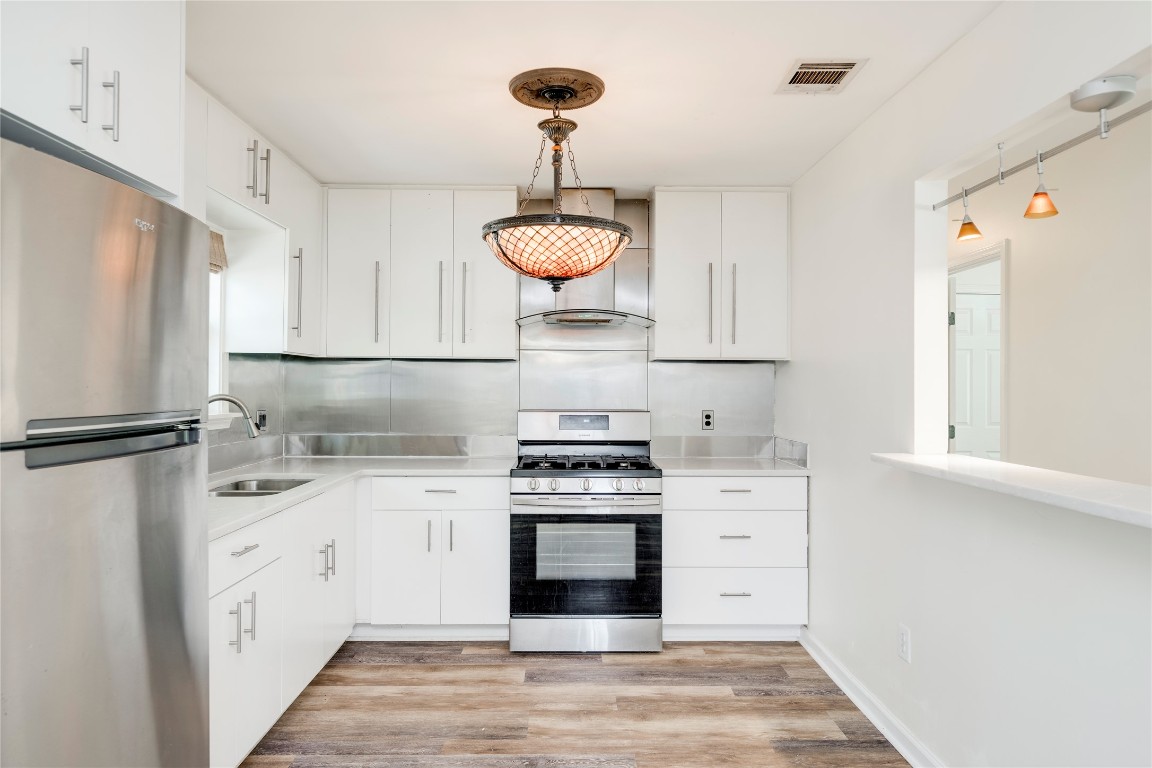 2903 South 5th Street Austin, TX 78704 - Photo 2 of 39 a kitchen with a stove and a refrigerator