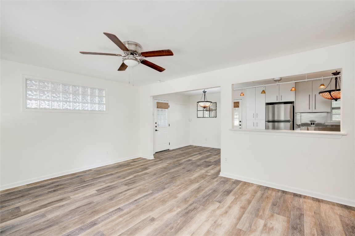2903 South 5th Street Austin, TX 78704 - Photo 21 of 39 a view of a kitchen with wooden floor and a ceiling fan