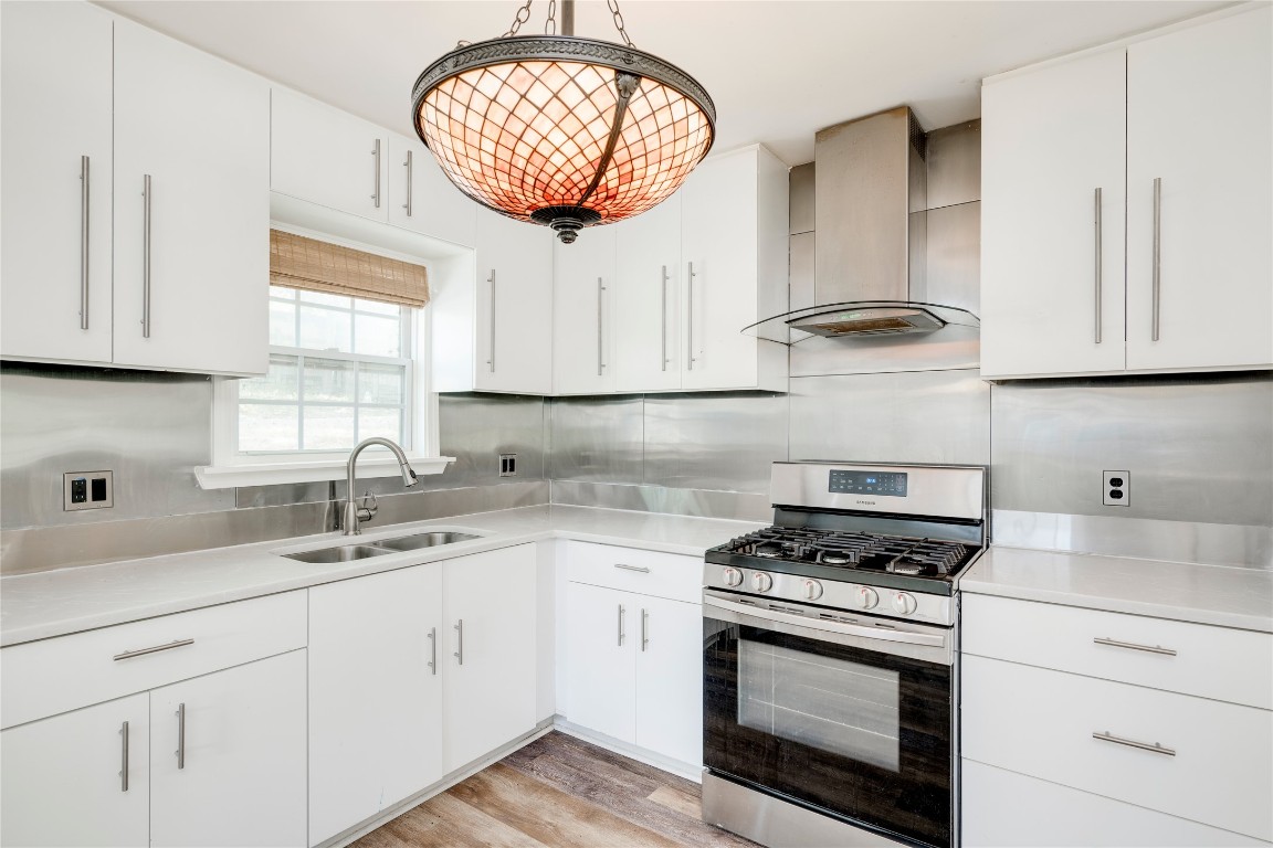 2903 South 5th Street Austin, TX 78704 - Photo 3 of 39 a kitchen with cabinets appliances a sink and a window