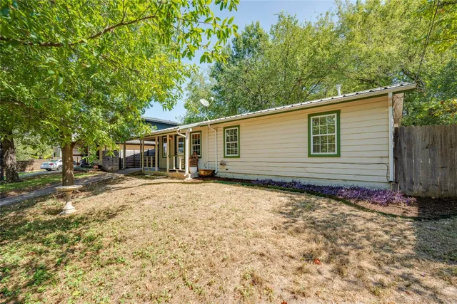 a backyard of a house with oven and trees