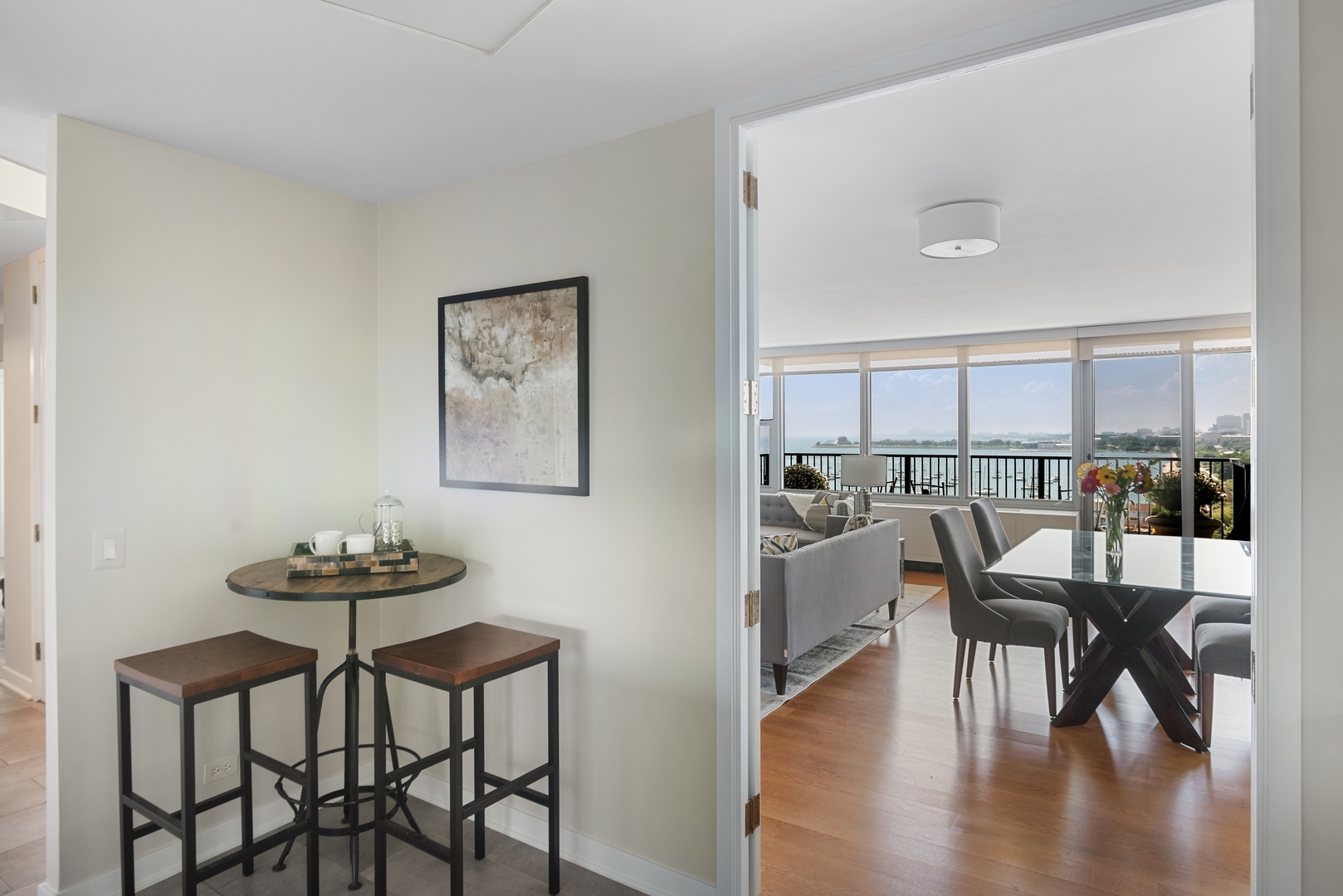 400 East Randolph Street, Unit 1403 Chicago, IL 60601 - Photo 5 of 17 a view of a dining room with furniture and wooden floor
