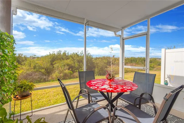 a view of a dining room with furniture and window