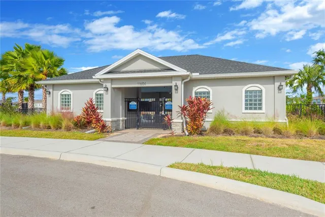 a sign board with a building in the background