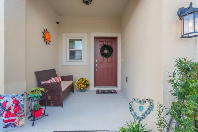 a living room with furniture and flowers