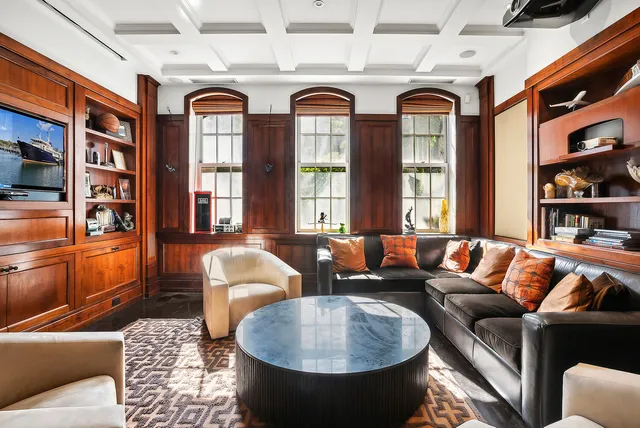 a living room with furniture fireplace and a large window