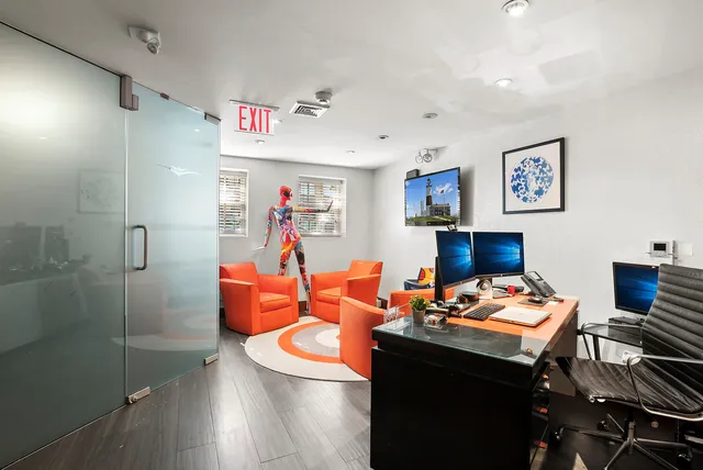 a bedroom with a bed couch and a large window