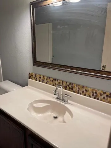 an empty room with a window and ceiling fan