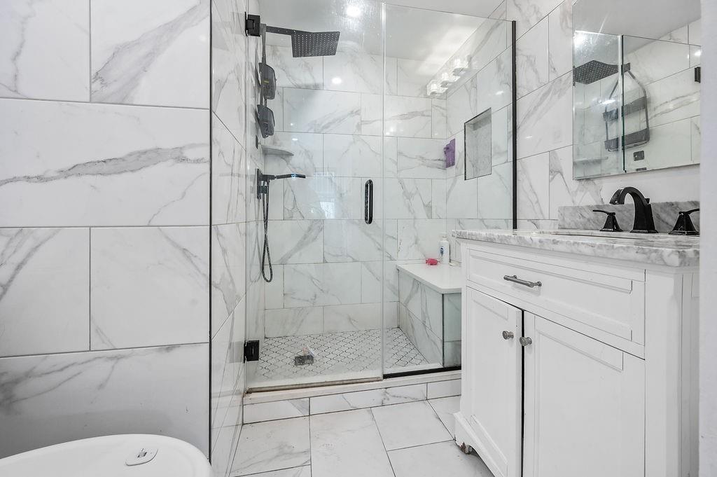 46 Rutherford Place Brooklyn, NY 11214 - Photo 11 of 20 a bathroom with a shower sink mirror and toilet