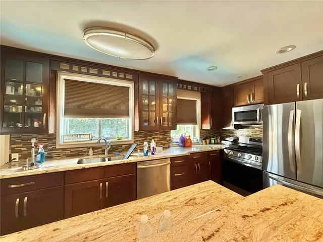 a kitchen with a sink stove and refrigerator
