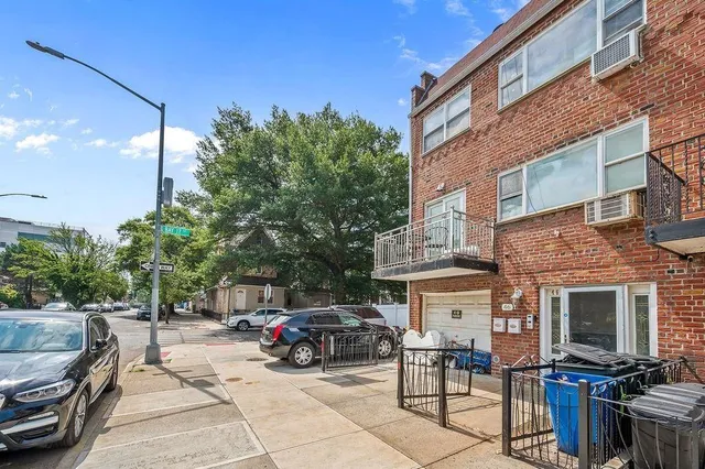 a view of a cars park in front of a building