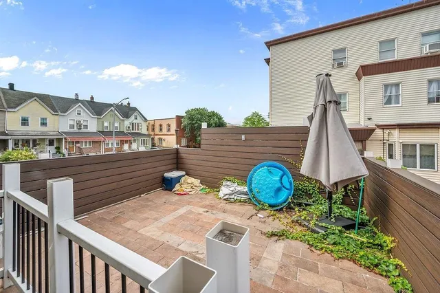 a wooden bench sitting in front of a house