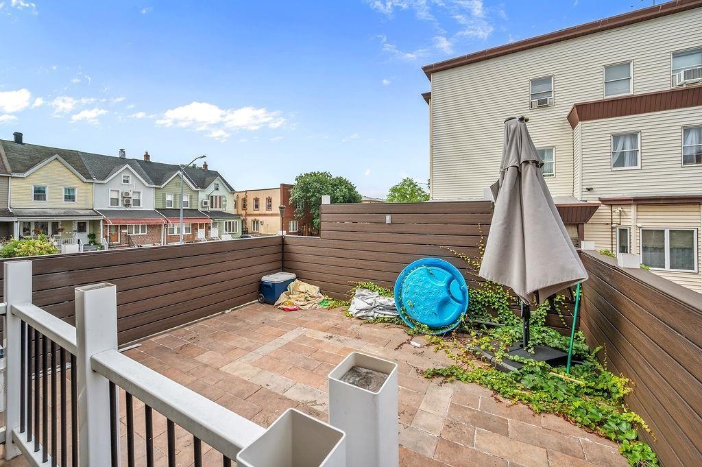 46 Rutherford Place Brooklyn, NY 11214 - Photo 17 of 20 a wooden bench sitting in front of a house