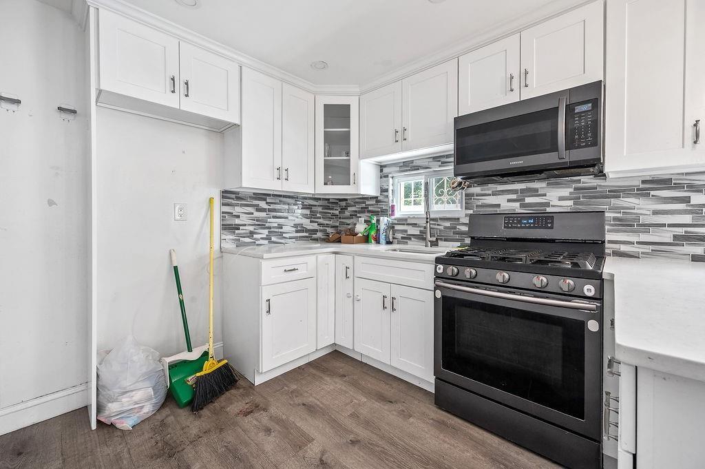 46 Rutherford Place Brooklyn, NY 11214 - Photo 6 of 20 a kitchen with stainless steel appliances a stove microwave and cabinets