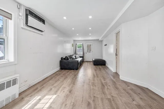 a big room with wooden floor and furniture