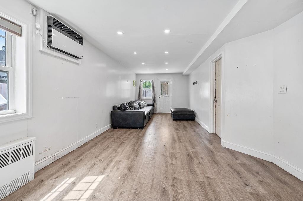 46 Rutherford Place Brooklyn, NY 11214 - Photo 8 of 20 a big room with wooden floor and furniture