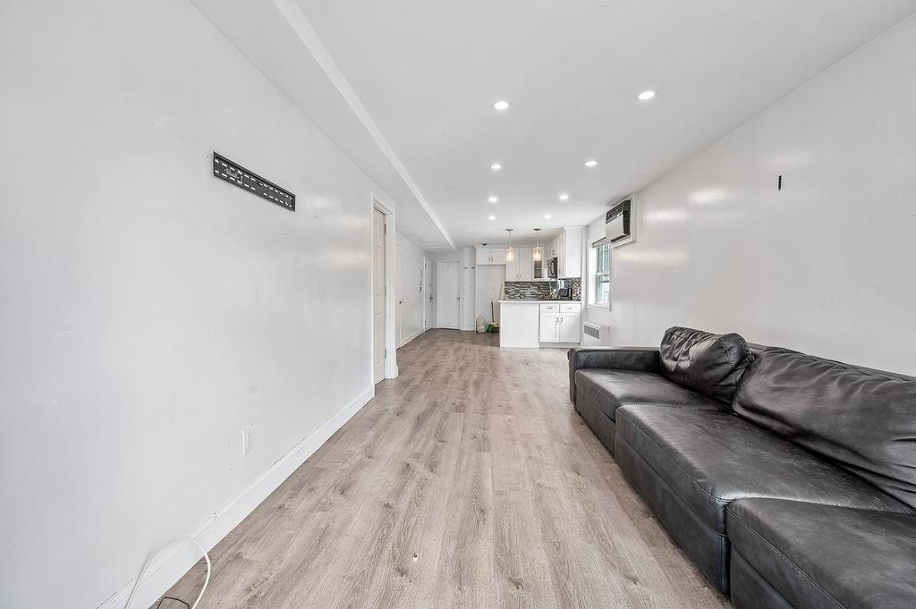 46 Rutherford Place Brooklyn, NY 11214 - Photo 9 of 20 a living room with furniture and a wooden floor