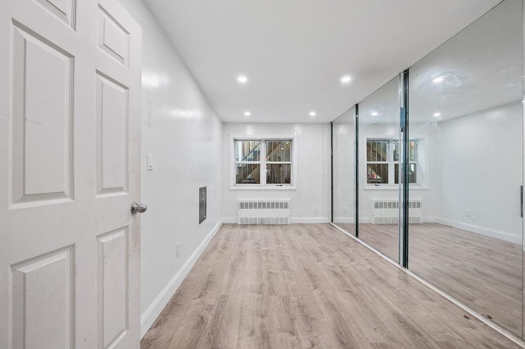 46 Rutherford Place Brooklyn, NY 11214 - Photo 10 of 20 a view of empty room with wooden floor and fan