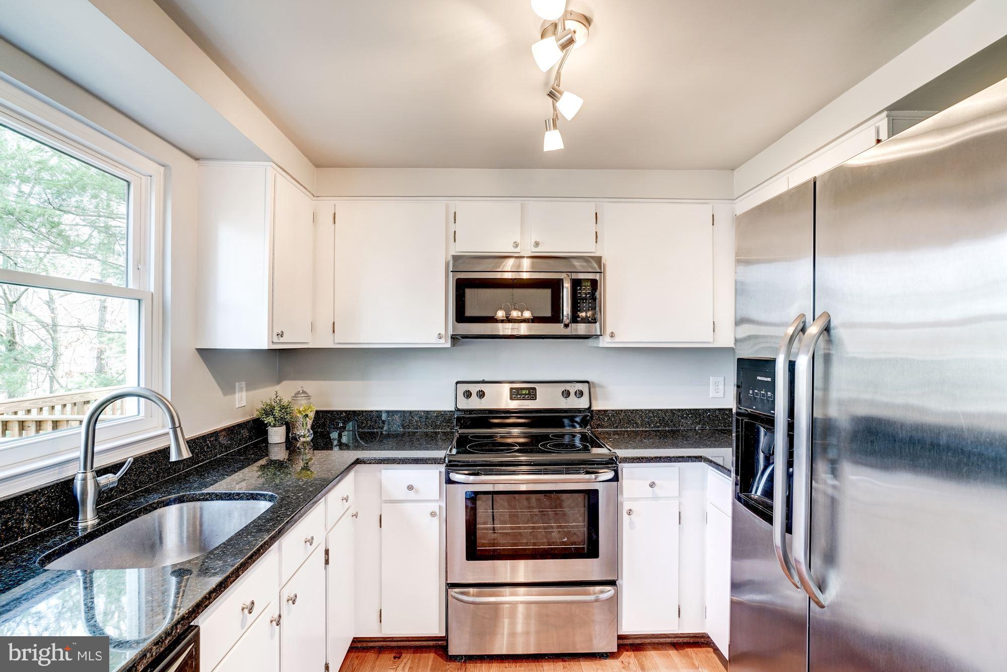 10968 Granby Court Reston, VA 20191 - Photo 10 of 33 a kitchen with granite countertop a stove and a sink