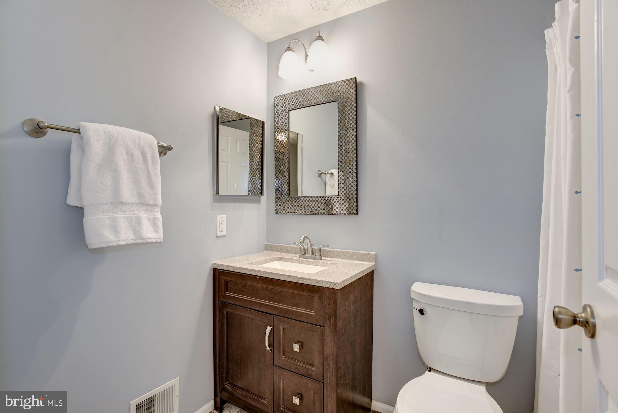 10968 Granby Court Reston, VA 20191 - Photo 18 of 33 a bathroom with a toilet sink and mirror