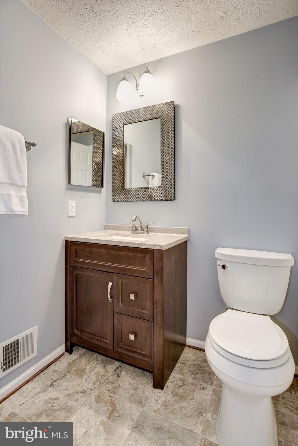 10968 Granby Court Reston, VA 20191 - Photo 19 of 33 a bathroom with a toilet sink and mirror