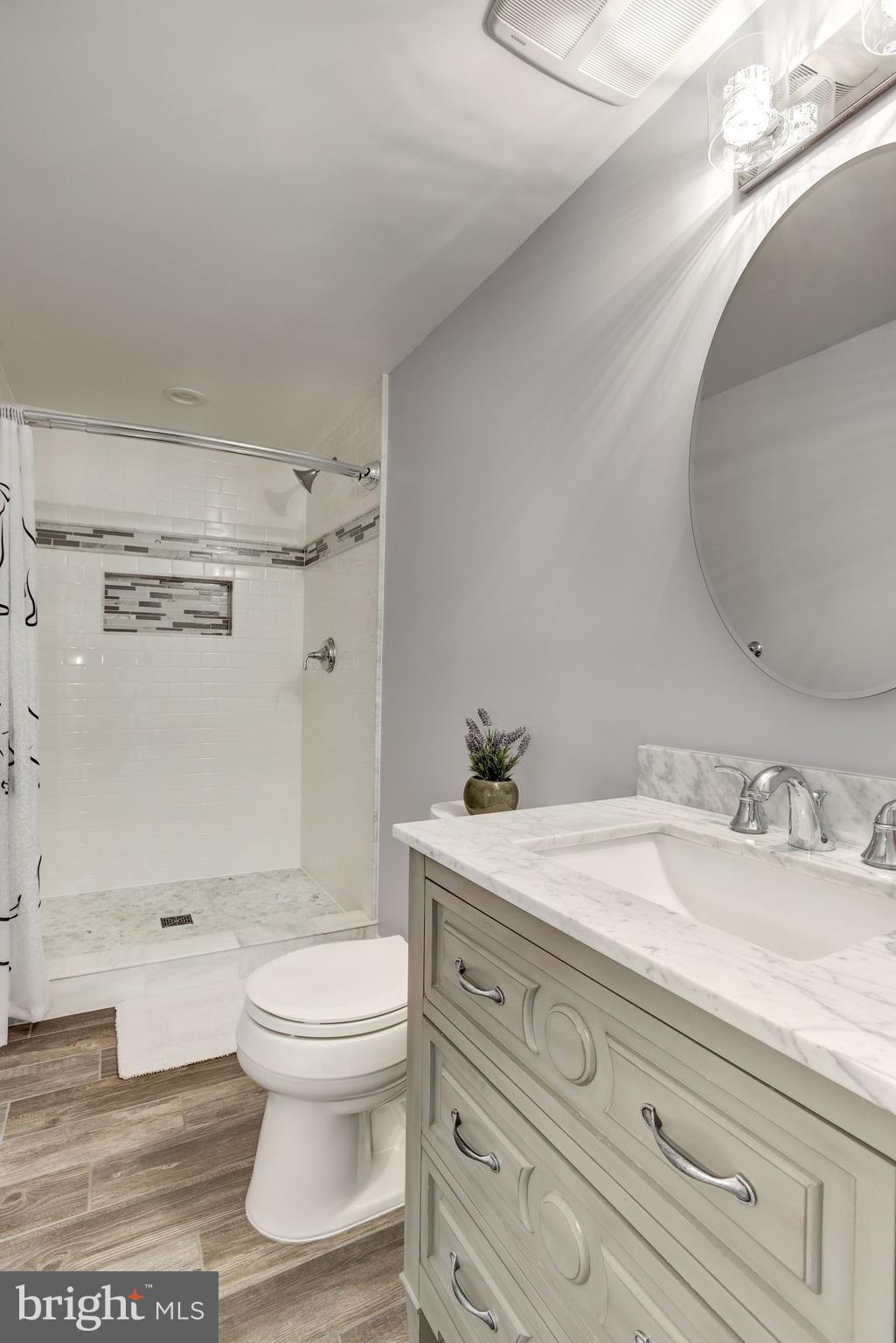 10968 Granby Court Reston, VA 20191 - Photo 29 of 33 a bathroom with a granite countertop toilet sink and mirror
