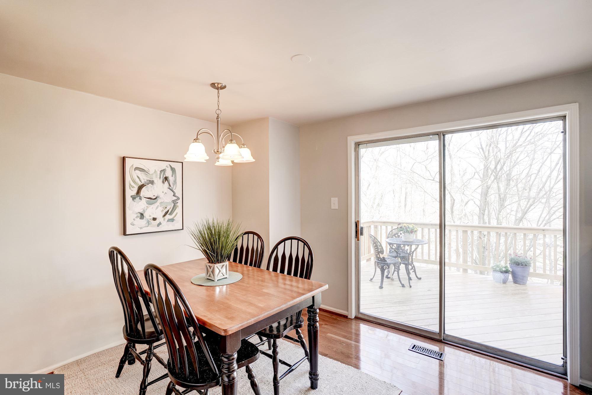 10968 Granby Court Reston, VA 20191 - Photo 7 of 33 a dining room with furniture a chandelier and wooden floor